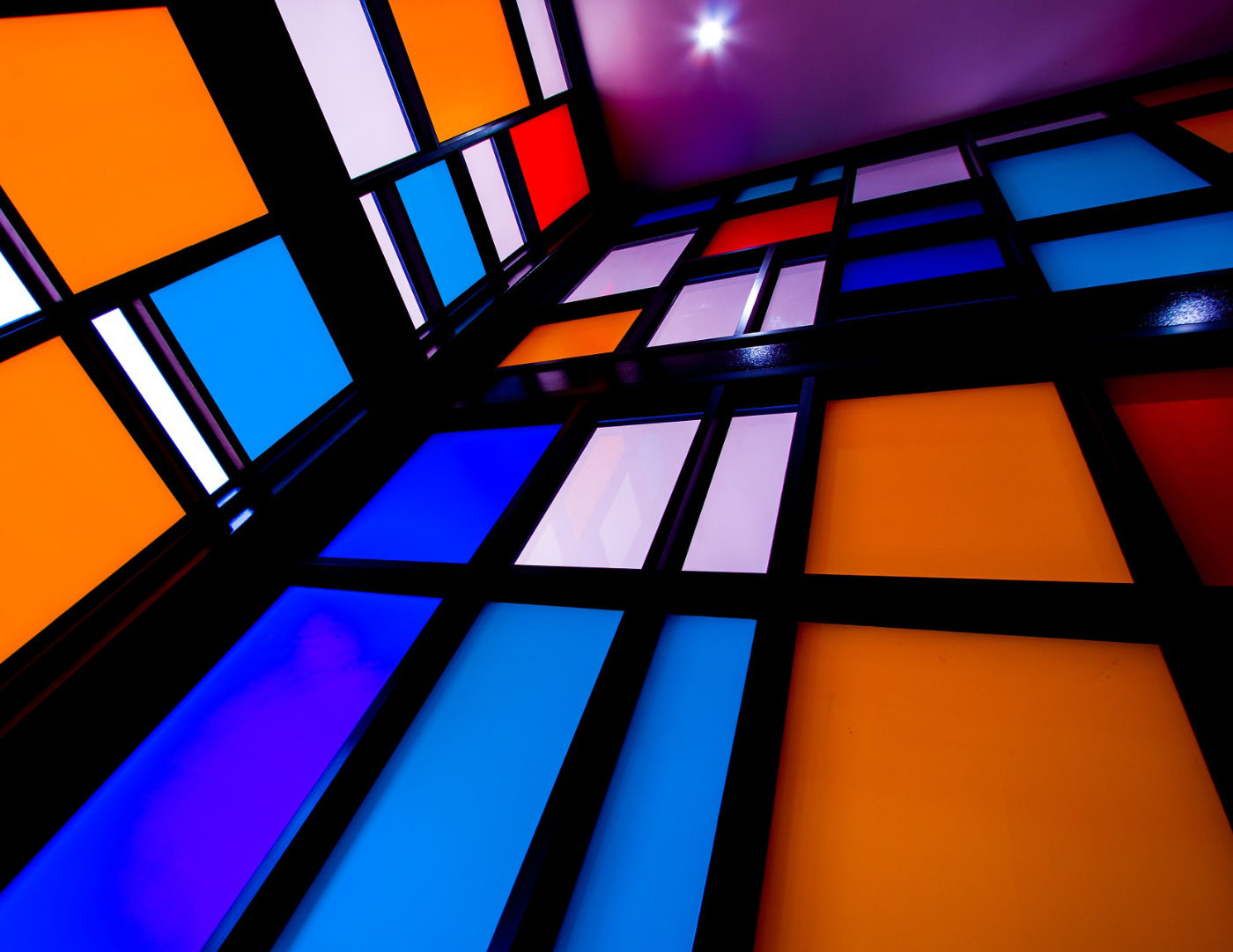 Mondrian-style glass walls in blues & orange in black frames via Pixabay